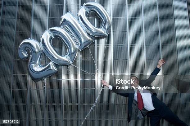 Empresario Se Llevar Por 2010 Globos Foto de stock y más banco de imágenes de 2010 - 2010, Adulto, Agarrar