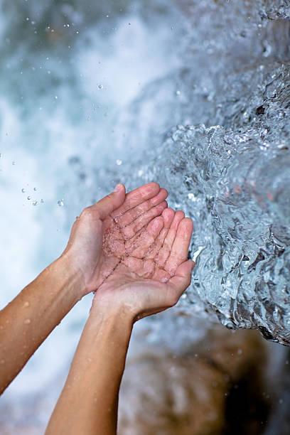 female hands and water like ice, vertical