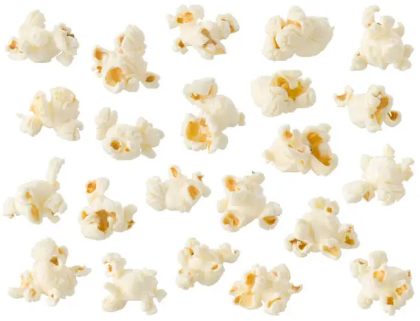 Photo of Arrangement of popcorn kernels isolated on white background