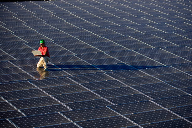 Background image: Three rows of solar panels receiving energy from the sun