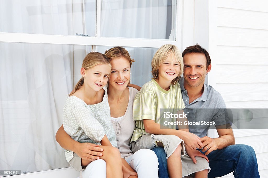 Familie sitzen zusammen vor Haus - Lizenzfrei 8-9 Jahre Stock-Foto
