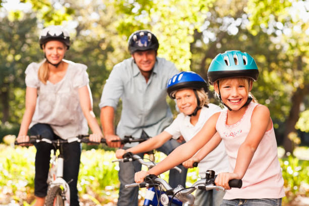istock Happy family riding bicycle at park 157503566