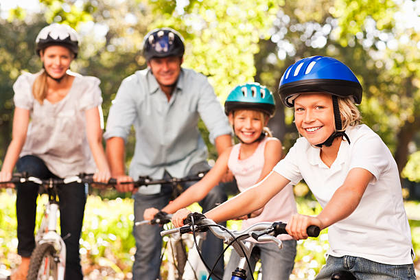 istock Happy family smiling while cycling at park 157503570