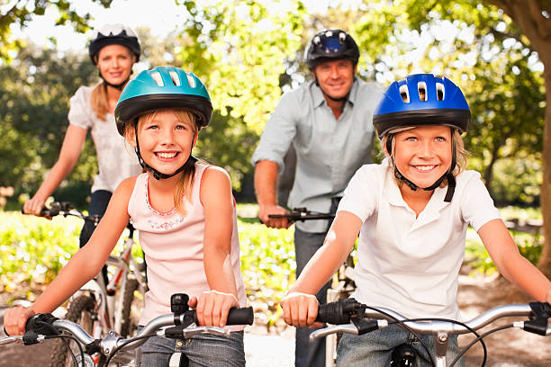 istock Family wearing helmets enjoying a bicycle ride 157503572