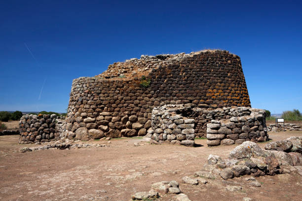 Nuraghe tower ruins and pine tree Sardinia Sardegna Italy archeological remnants of prehistoric building of bronze age ancient civilization tourism and archeology