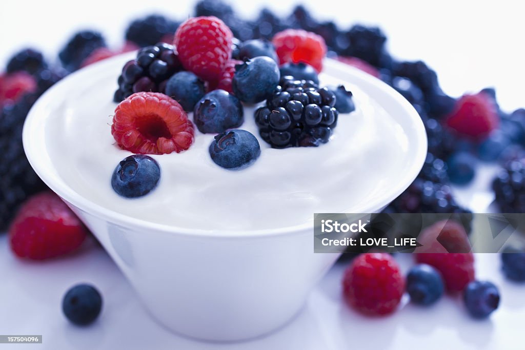 Yogurt and fruit. Yogurt with Blueberries, Blackberries, Raspberries. Selective focus,on a white background. Yogurt Stock Photo