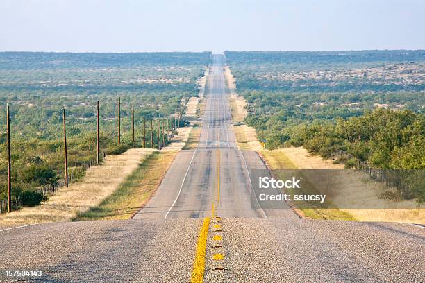 Rural Country Road Long And Straight Undulating To The Horizon Stock Photo - Download Image Now