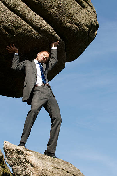 istock Businessman Holds Up Huge Boulder in the Sky 157504242