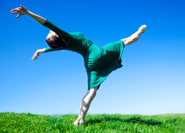 istock ecstatic modern dancer lifting leg to the sky 157504281