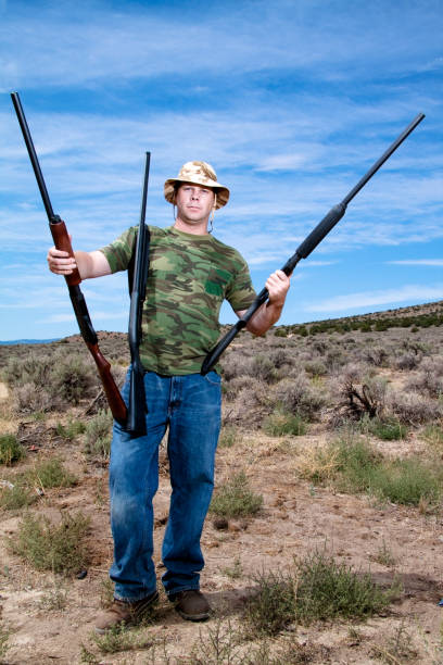 istock Hunter with three rifles outdoors 157504327