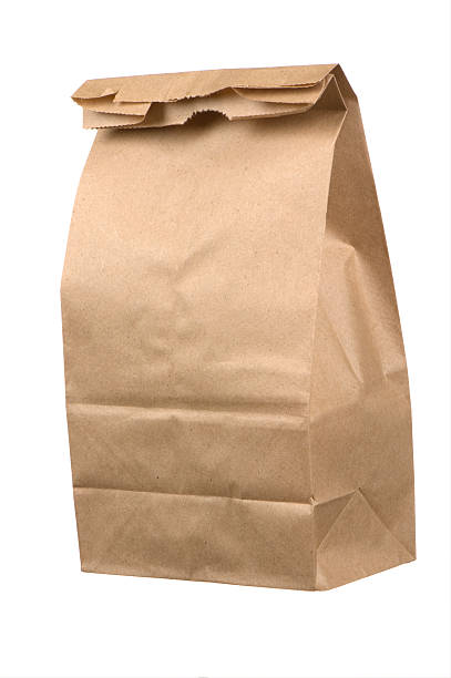 istock Closed brown paper lunch bag on white background 157504345