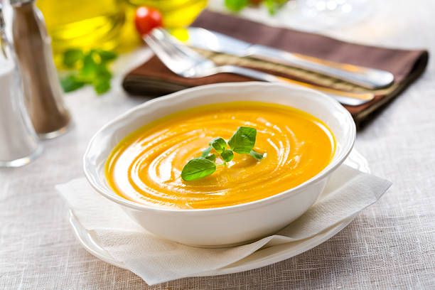 White bowl of pumpkin soup with garnish bowl of pumpkin soup  pumpkin soup photos stock pictures, royalty-free photos & images