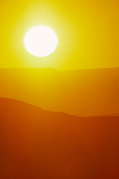 istock Hot Summer Sunrise with Large Sun and Bright Yellow Sky 157504494
