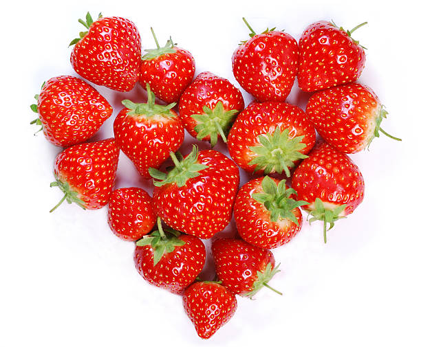 Ripe strawberries laying in a heart shape