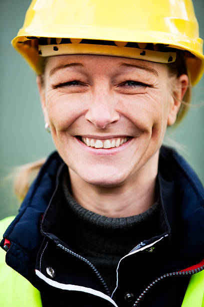 istock Happy Manual Female Worker In Yellow Hardhat 157504791