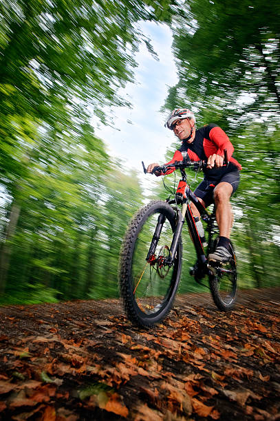 istock Low angle blurred view of man with a helmet mountain biking 157505283