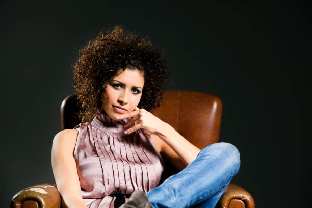 istock Model with afro hair sitting on armchair 157505329