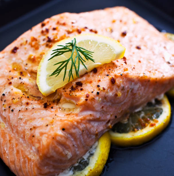 istock Baked salmon garnished with a slice of lemon 157505471