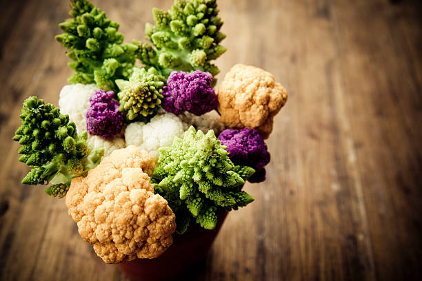 Bouquet of multi colored cauliflowers and romanesco broccoli.