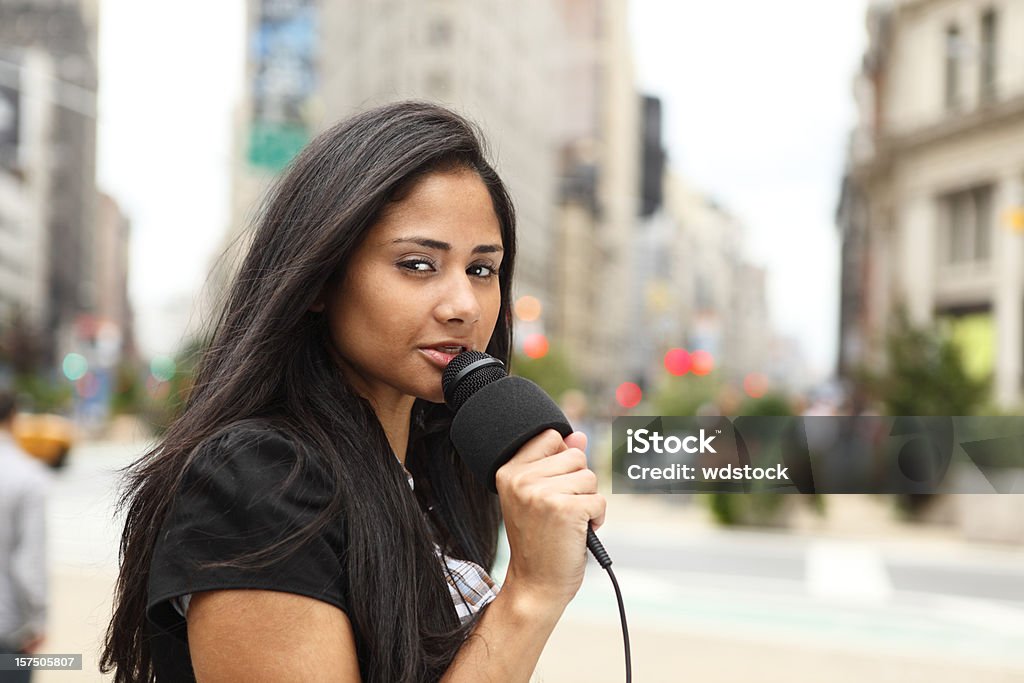 Newscaster A female newscaster talking into her microphone. 30-39 Years Stock Photo