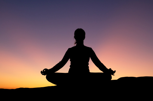 yoga pose on mountain during sunset, International yoga day concept image with copy space for text, World meditation day