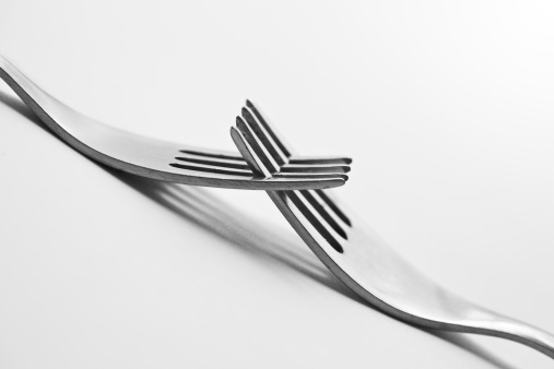 Two Crossed forks on gray background. Copy space