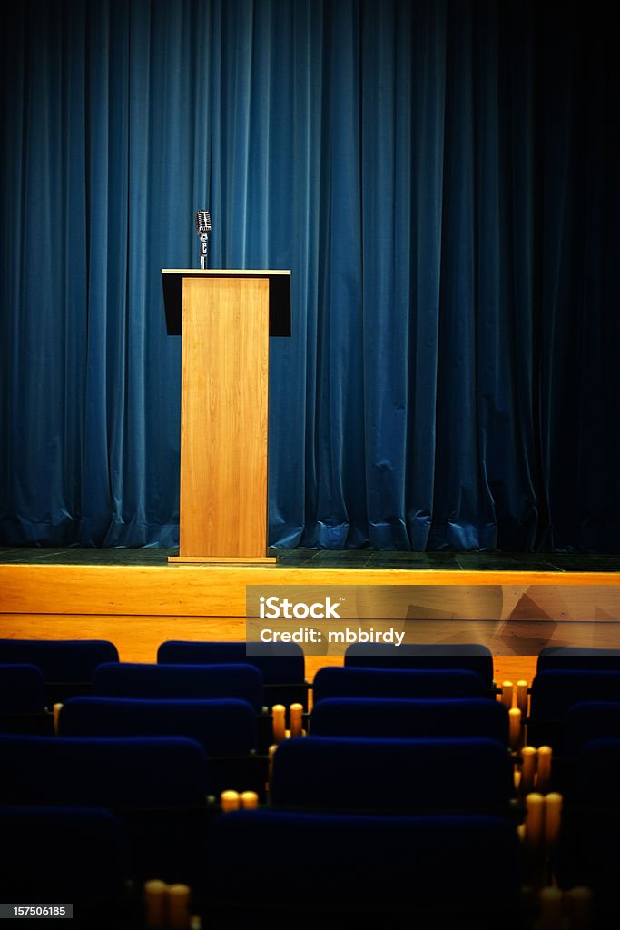 Conference hall with rostrum and microphone Rostrum with retro microphone and curtain behind. Waiting for speech. Just add text or person on photo! Be creative.  Lectern Stock Photo
