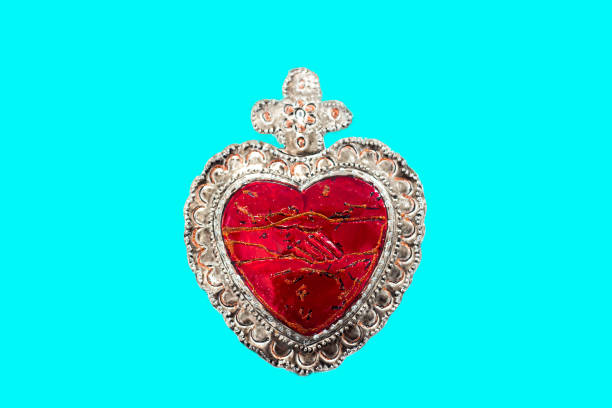 istock Red Tin Milagros Heart on Turquoise Background 1575064793