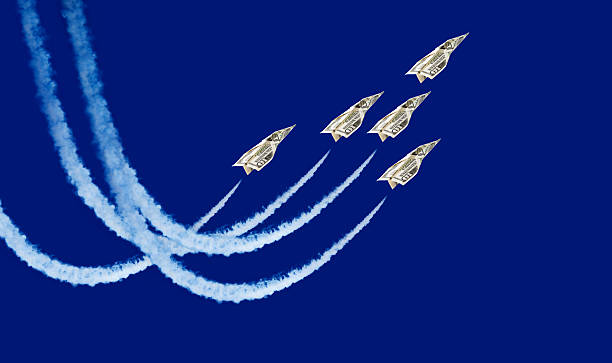 Five paper planes flying through the sky flight of paper planes aerobatics photos stock pictures, royalty-free photos & images