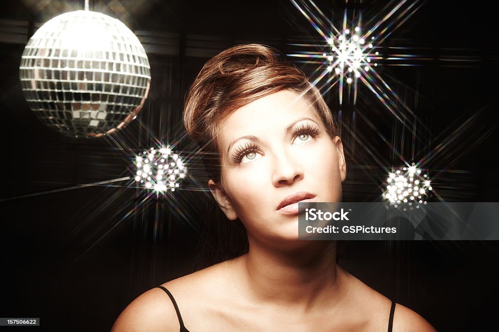 Woman Posing for Camera By Disco Ball A young woman is posing for the camera.  Horizontally framed shot. One Woman Only Stock Photo