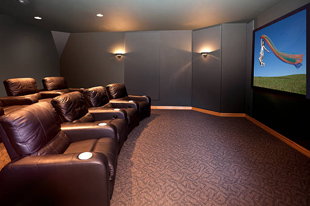 Home Theater Room With Leather Recliners Home theater room with leather recliners and sconce lights. Place an image you like on the screen.  surround sound stock pictures, royalty-free photos & images