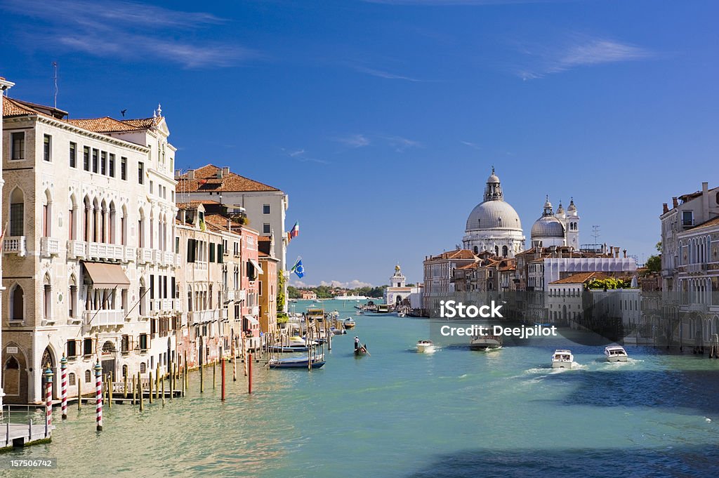 Grand Canal and Santa Maria della Salute Church Venice Italy The Grand Canal and Santa Maria della Salute church in Venice, Italy. Boats moving on the river under a clear blue summer sky. Venice - Italy Stock Photo