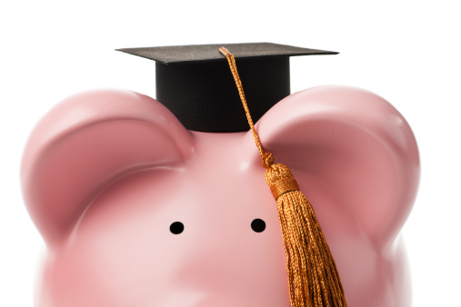 Subject: A piggy bank wearing a graduation hat isolated on a white background.
