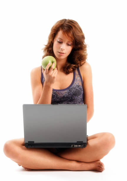 istock girl surfing the internet and eating apple 157506868