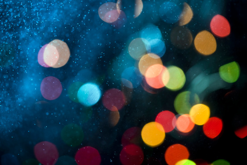 Water dust in motion like snow and defocused lights at night. Abstract Background