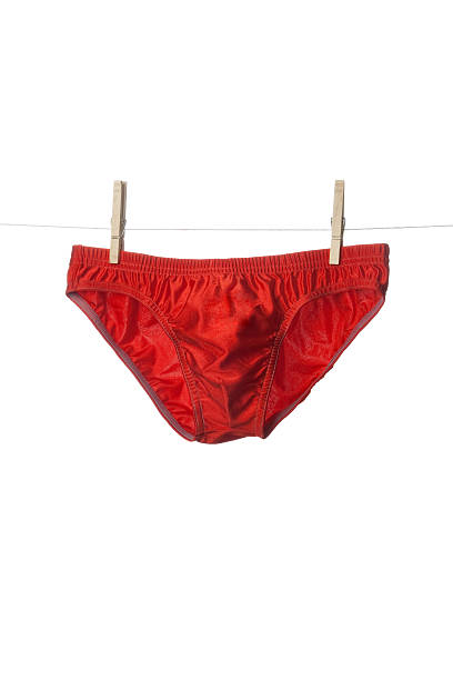 красные трусики-шорты - swimming trunks bikini swimwear red стоковые фото и изображения