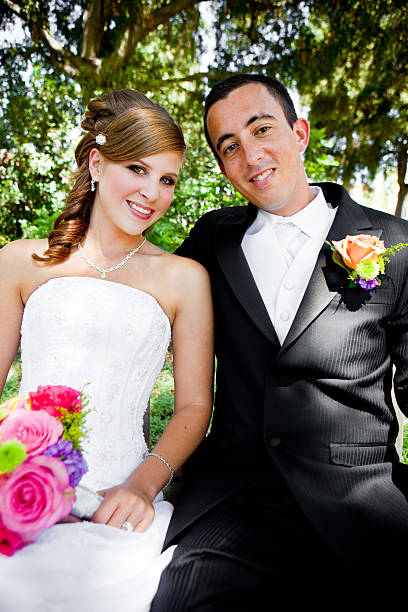 istock bride and groom relaxing at park 157507212