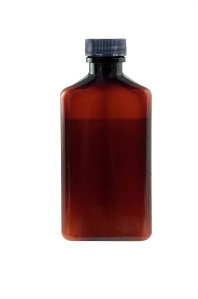 A brown bottle partly filled with liquid and with a clipping path... copy space on the bottle surface.