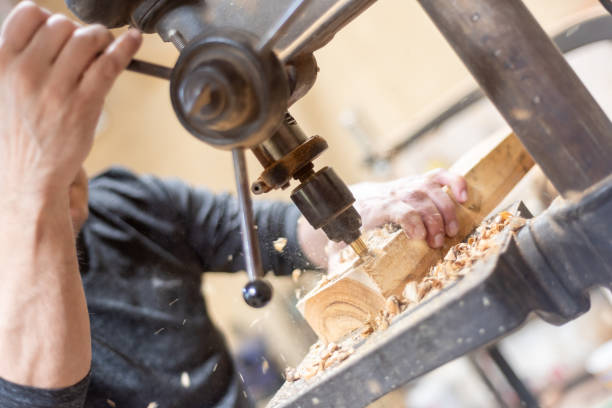 istock Carpenter drilling hole in wood 1575072800
