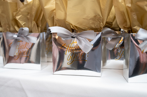 Goodie bags on a table with printed Thank you message