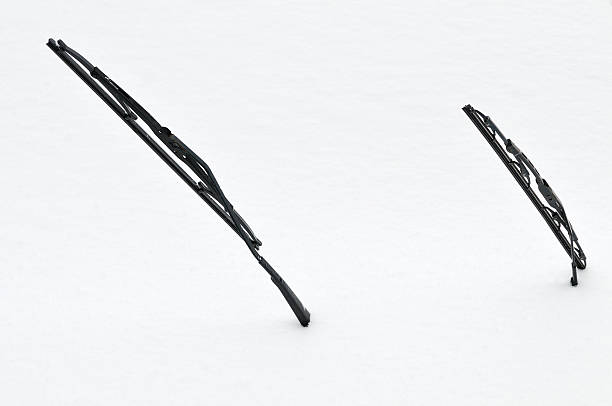 Two windscreen wipers poking out of a blanket of snow First snow on a car windshield wiper photos stock pictures, royalty-free photos & images