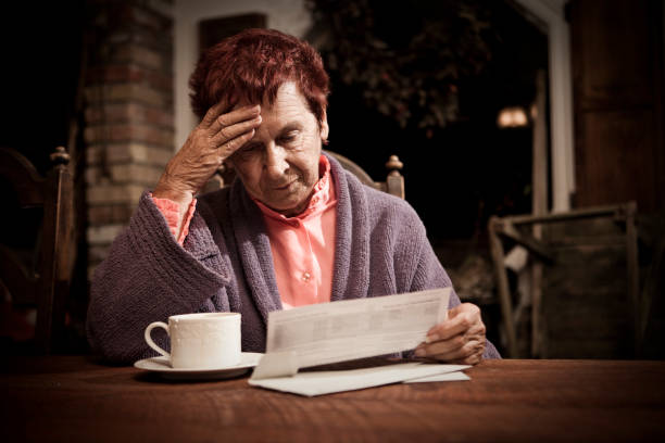 Distressed Senior Woman with Bills stock photo