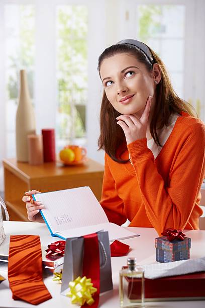 Young woman preparing gifts stock photo