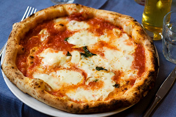 Authentic, Neapolitan margherita pizza Pizza Margherita, made with tomato, sliced mozzarella, basil and extra-virgin olive oil, photographed in a true neapolitan pizzeria. mozzarella photos stock pictures, royalty-free photos & images