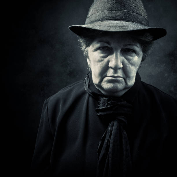 istock spooky senior lady wearing dark clothes 157508429
