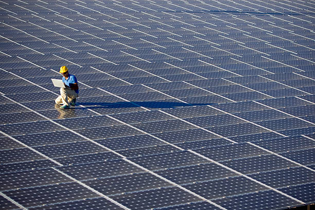 An engineer working at a photovoltaic farm stock photo