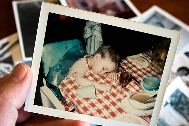 Hand holds Vintage photograph of boy at thanksgiving stock photo
