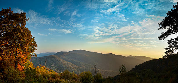 Blue Ridge Mountains in Autumn Panorama The early morning Autumn sun breaks over the mountains in Shenandoah National Park bringing out the brilliant reds and oranges of the deciduous trees. appalachian mountains photos stock pictures, royalty-free photos & images