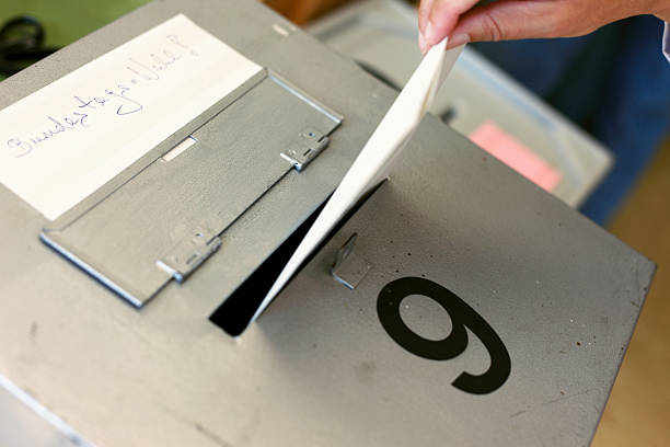 Bundestag election Ballot Box Germany Voting ballot being inserted in a ballot box in Germany. german federal elections photos stock pictures, royalty-free photos & images