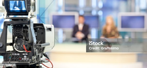 istock Two newsreader in front of television camera 157508633